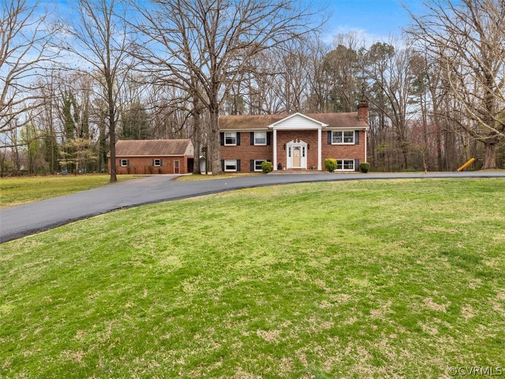 695 Three Chopt Road Manakin-Sabot, VA 23103 - Photo 3 of 43 a front view of a house with garden