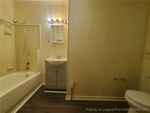 a bathroom with a tub shower vanity and a sink