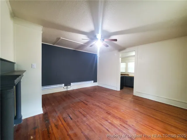 a view of a house with a small yard plants and large tree