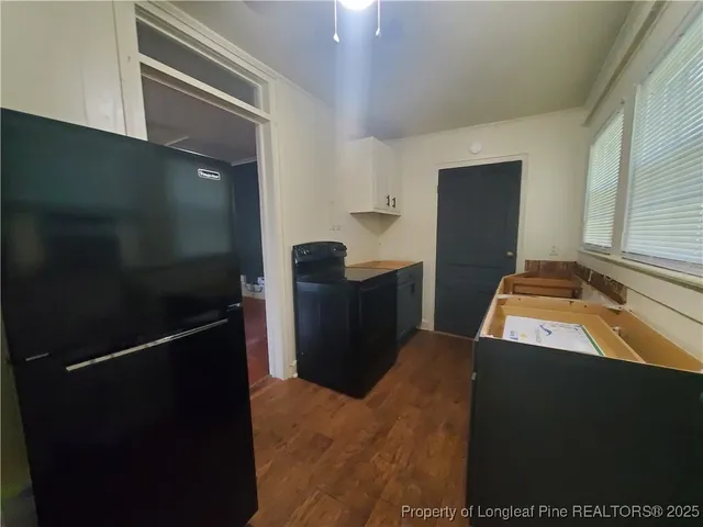 a kitchen with a sink appliances and cabinets