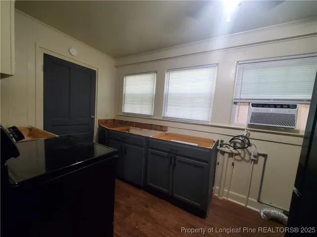 a kitchen with refrigerator and window