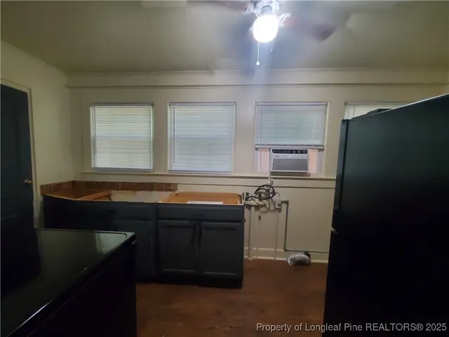 a kitchen with a refrigerator and a sink