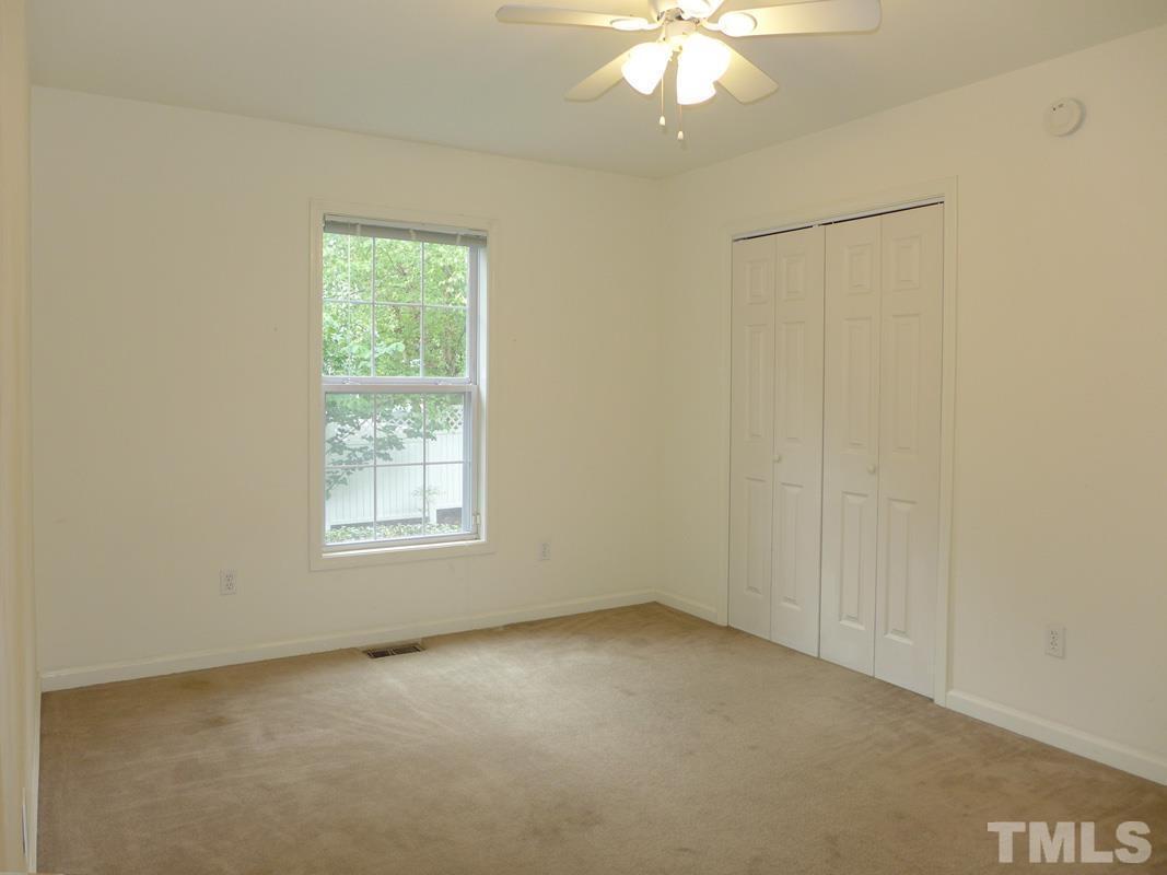 308 Davie Road Carrboro, NC 27510 - Photo 12 of 21 an empty room with a chandelier fan and window