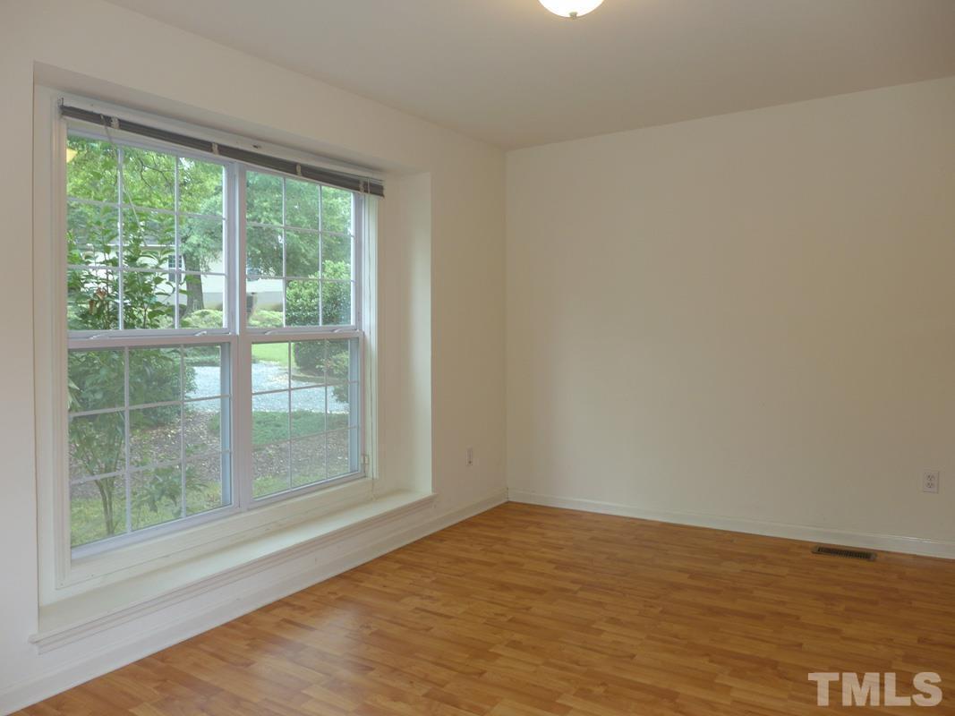 308 Davie Road Carrboro, NC 27510 - Photo 6 of 21 a view of empty room with wooden floor and fan