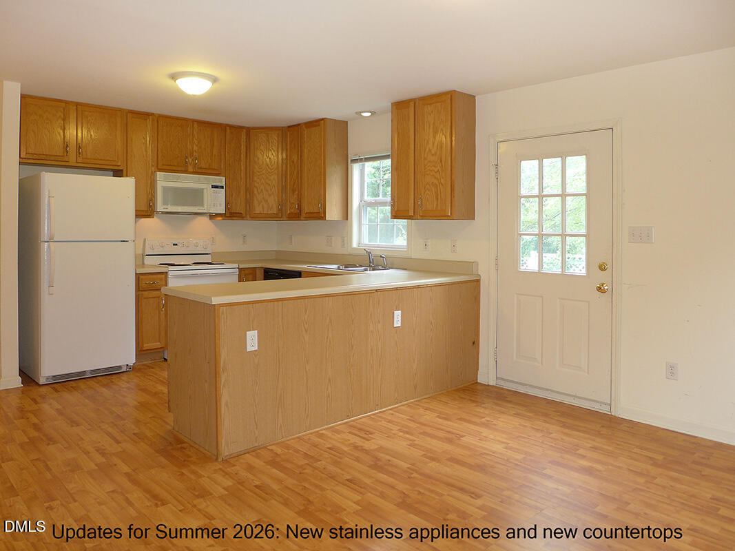 308 Davie Road Carrboro, NC 27510 - Photo 9 of 21 a kitchen with stainless steel appliances granite countertop a stove a sink and a refrigerator