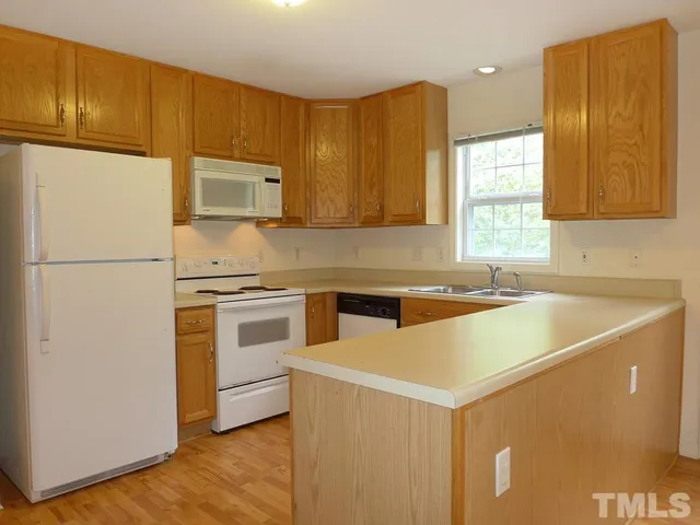 a kitchen with a cabinets and white appliances