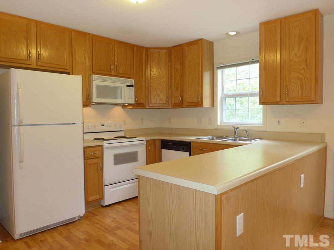 308 Davie Road Carrboro, NC 27510 - Photo 10 of 21 a kitchen with a cabinets and white appliances
