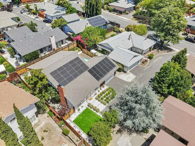 an aerial view of a house with a yard