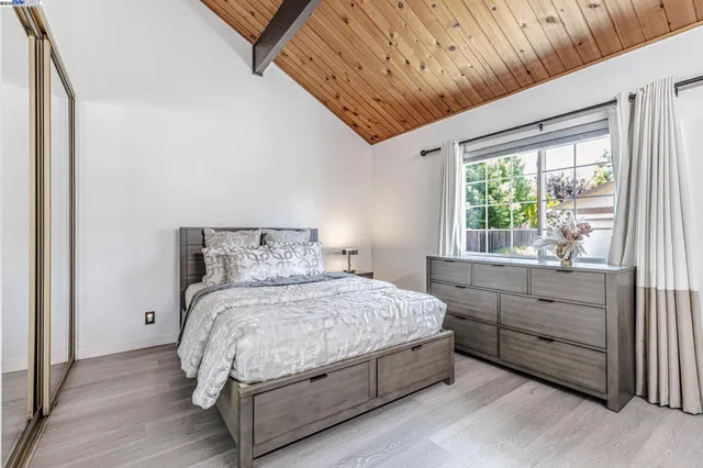 a bedroom with a large bed and a large window