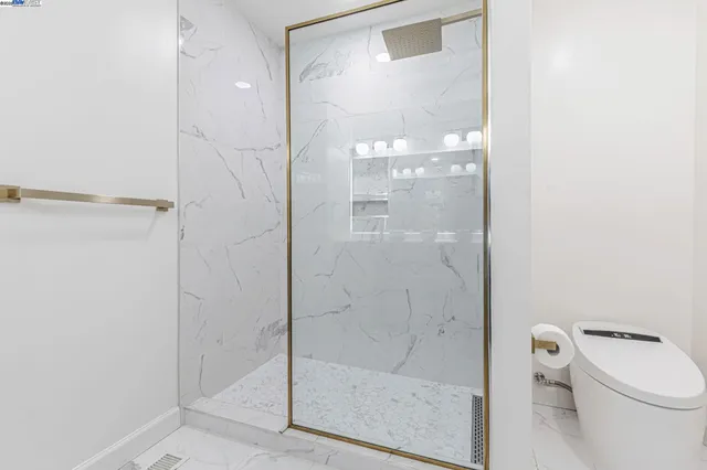 a bathroom with a granite countertop sink a vanity and a large mirror
