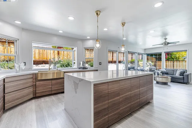 a kitchen with counter top space and living room