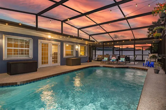 a swimming pool with outdoor seating and yard