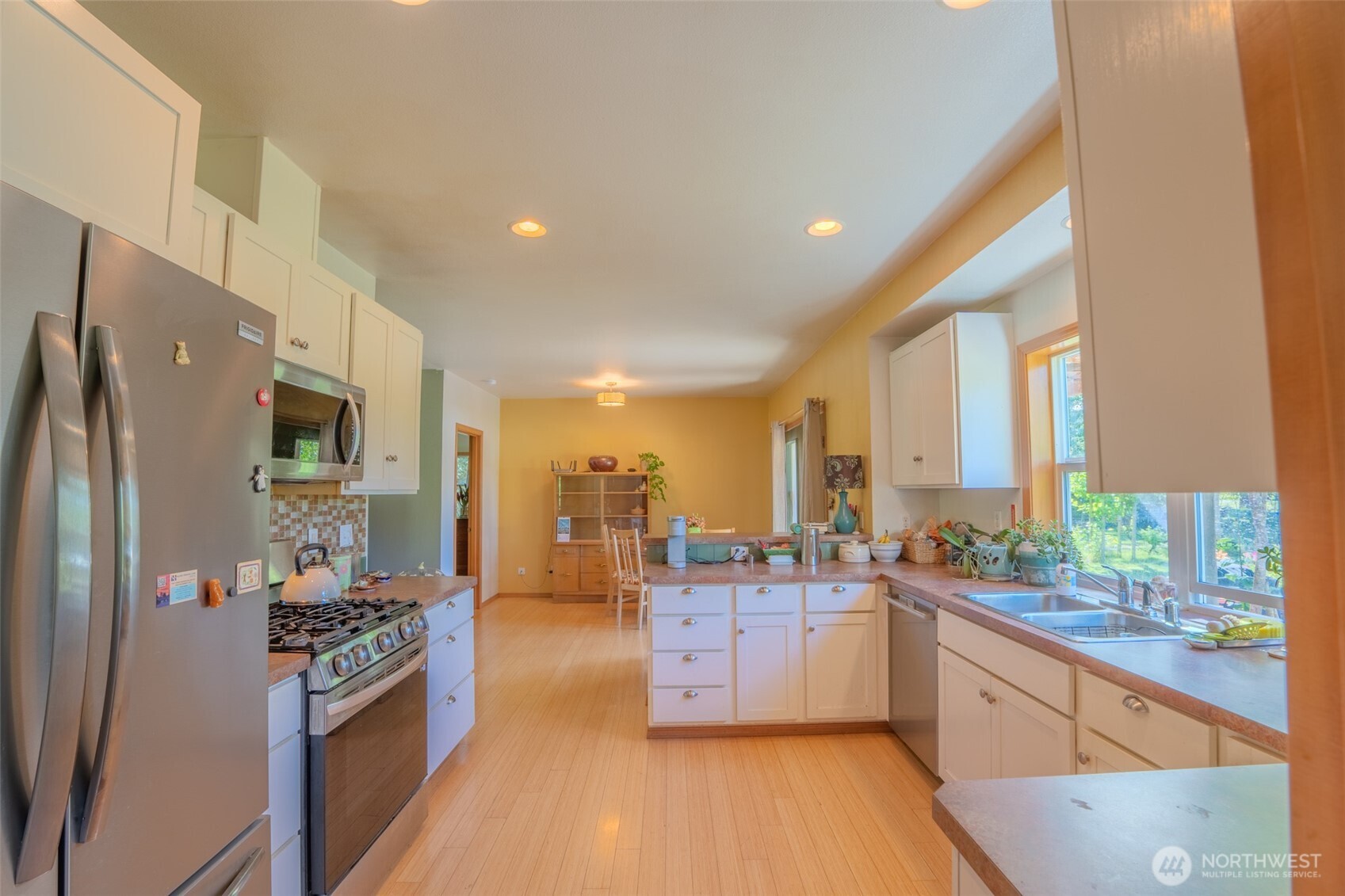5178 Orcas Road Orcas Island, WA 98245 - Photo 5 of 37 a large kitchen with stainless steel appliances a center island and a large window