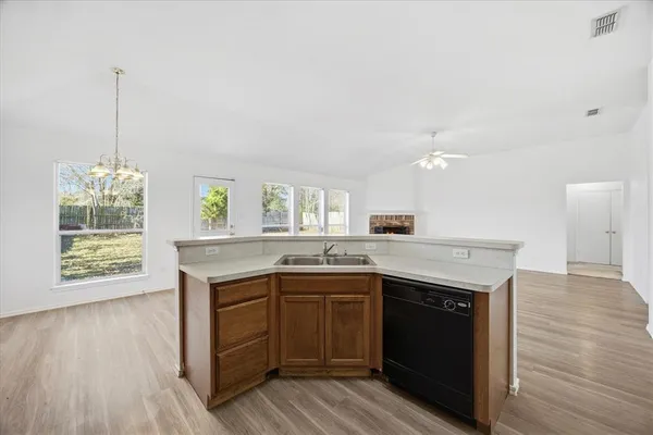 a kitchen with granite countertop a sink and cabinets
