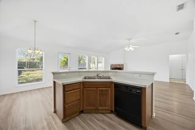 a kitchen with granite countertop a sink and cabinets