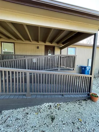 a view of a porch with wooden floor