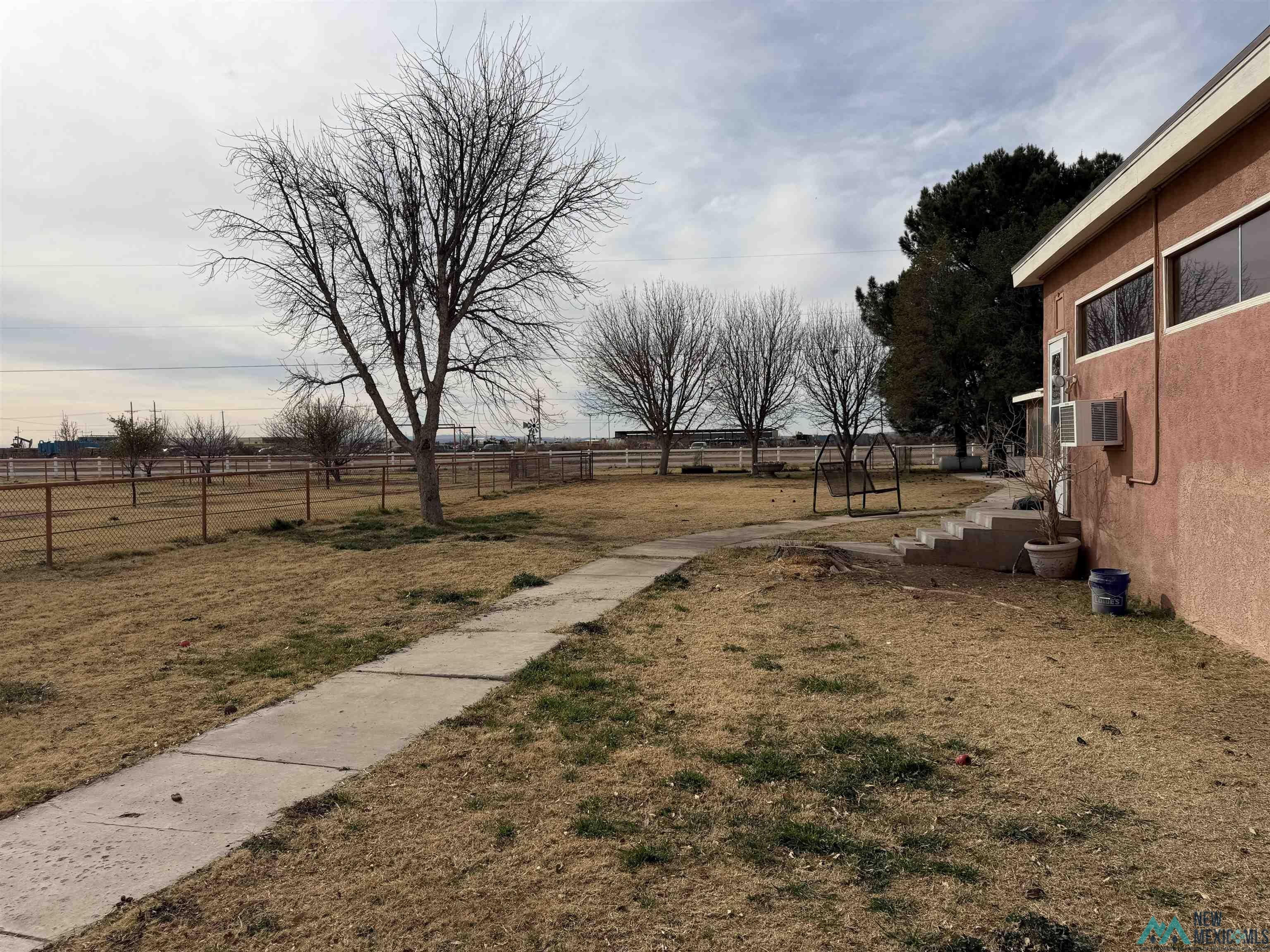 2001 East Derrick Road Carlsbad, NM 88220 - Photo 13 of 84 Fenced backyard featuring a view of countryside