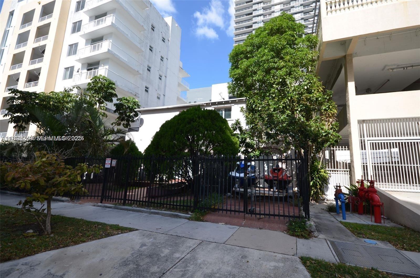 437 Northeast 30th Street Miami, FL 33137 - Photo 5 of 6 a view of a building with a garden