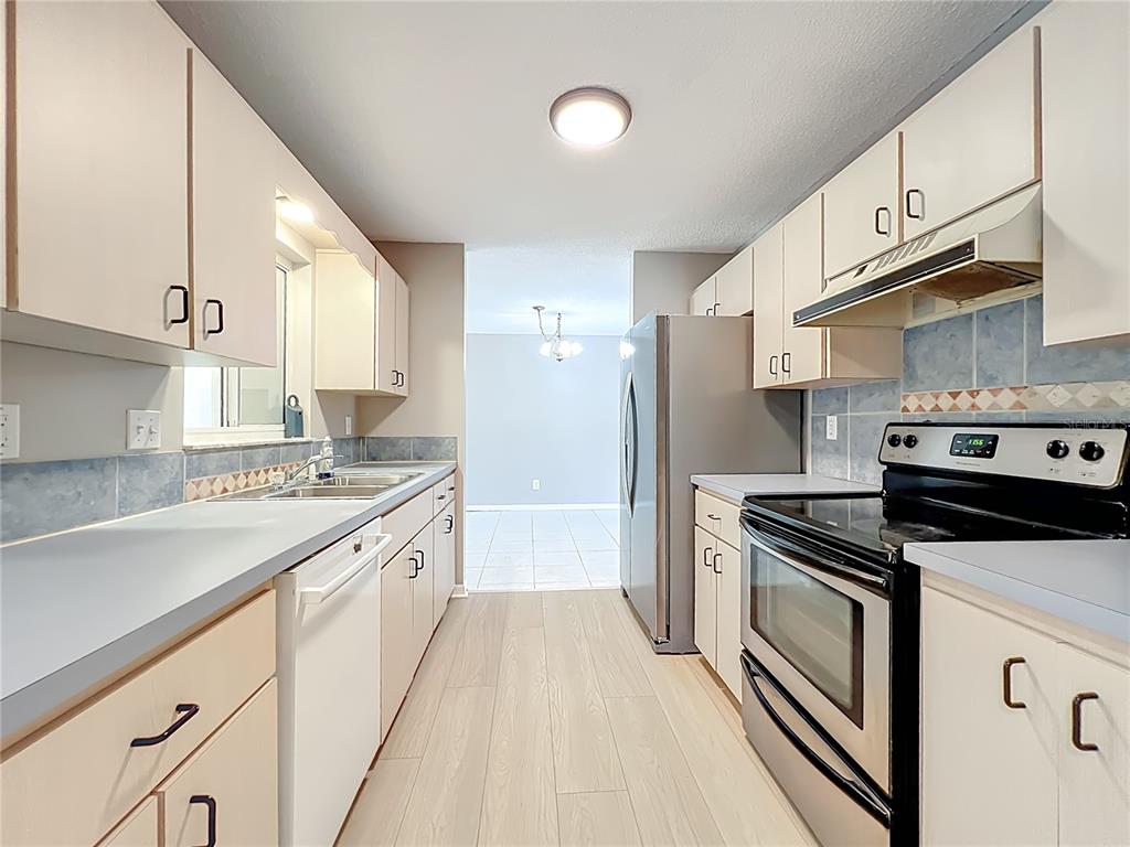 10583 Southwest 62nd Ter Road Ocala, FL 34476 - Photo 19 of 59 a kitchen with stainless steel appliances granite countertop a sink a stove a refrigerator and cabinets