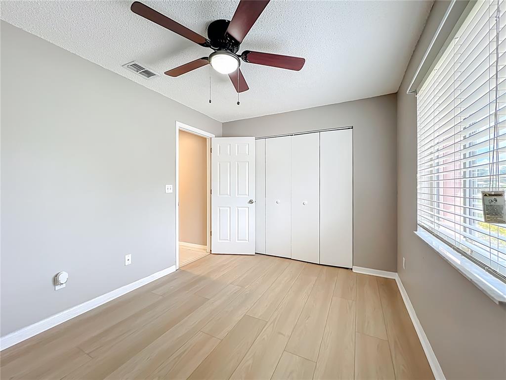 10583 Southwest 62nd Ter Road Ocala, FL 34476 - Photo 23 of 59 a view of an empty room with a window and wooden floor