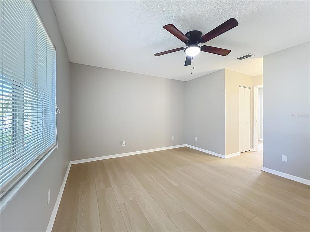 10583 Southwest 62nd Ter Road Ocala, FL 34476 - Photo 26 of 59 an empty room with ceiling fan and window