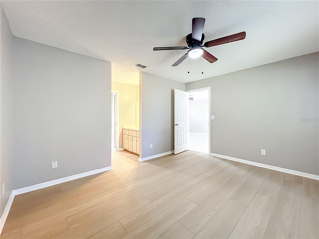10583 Southwest 62nd Ter Road Ocala, FL 34476 - Photo 27 of 59 an empty room with ceiling fan and window
