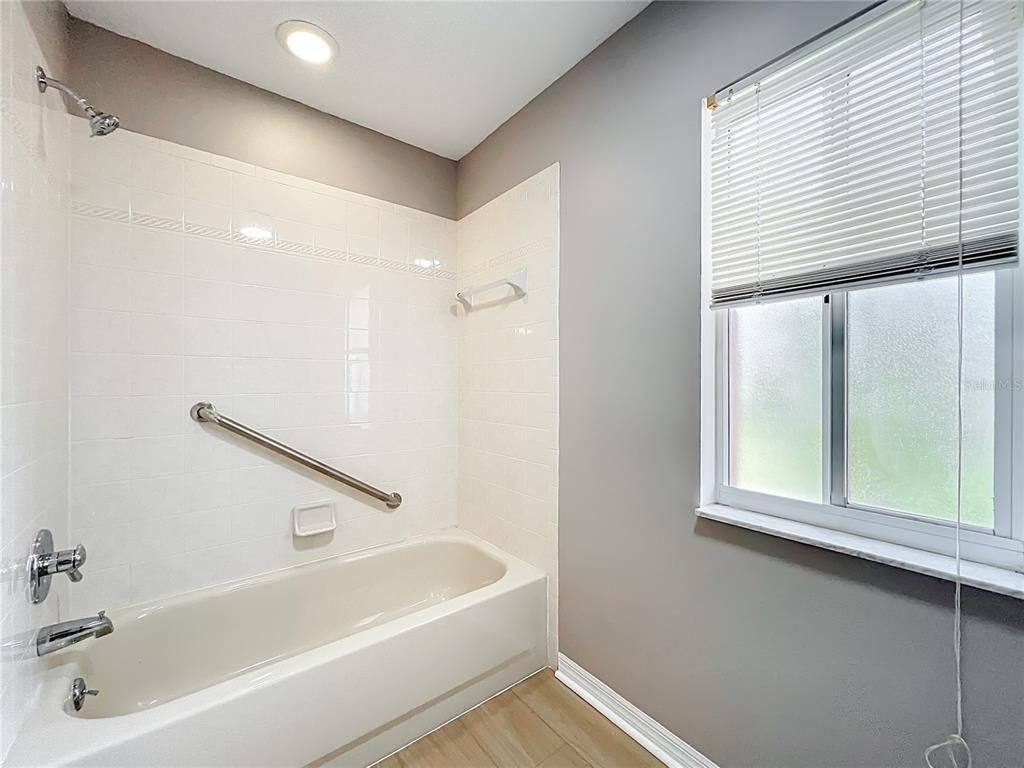 10583 Southwest 62nd Ter Road Ocala, FL 34476 - Photo 29 of 59 a bathroom with a bathtub and a window