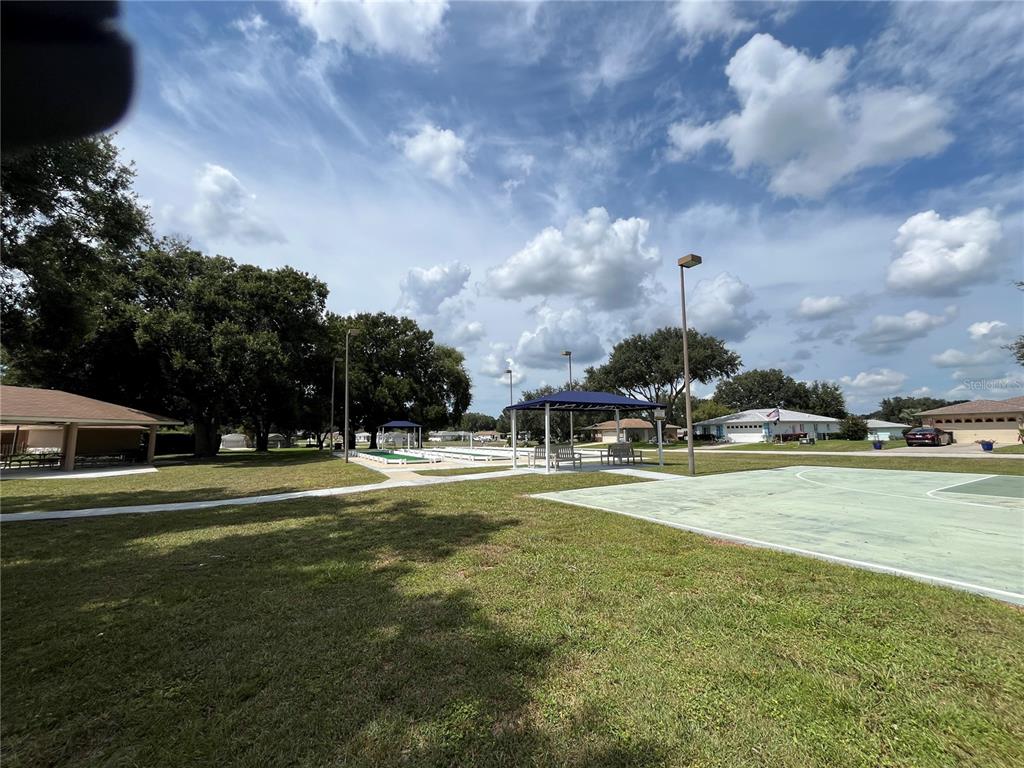 10583 Southwest 62nd Ter Road Ocala, FL 34476 - Photo 58 of 59 a swimming pool with lots of trees and buildings in the background