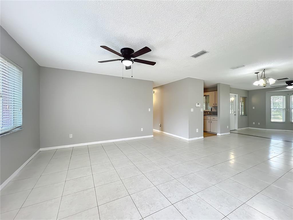 10583 Southwest 62nd Ter Road Ocala, FL 34476 - Photo 7 of 59 an empty room with fan and windows