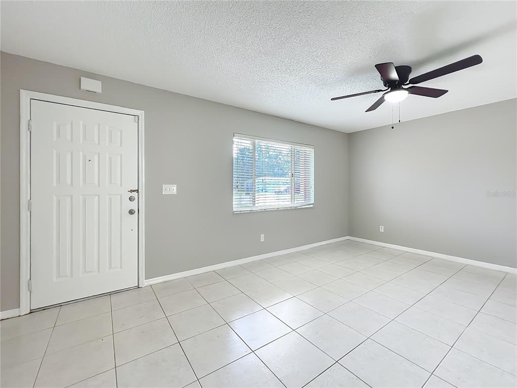 10583 Southwest 62nd Ter Road Ocala, FL 34476 - Photo 8 of 59 an empty room with windows and fan