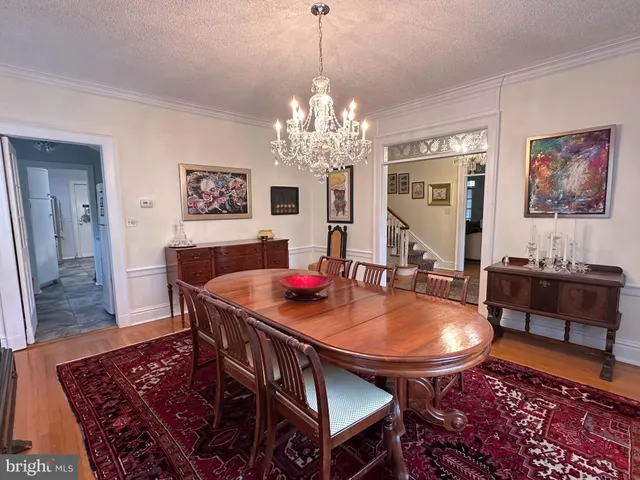 a dining room with furniture a rug and a chandelier