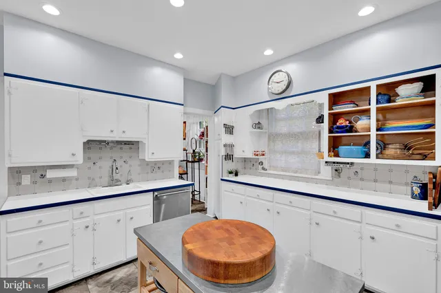 a kitchen with stainless steel appliances a sink and cabinets
