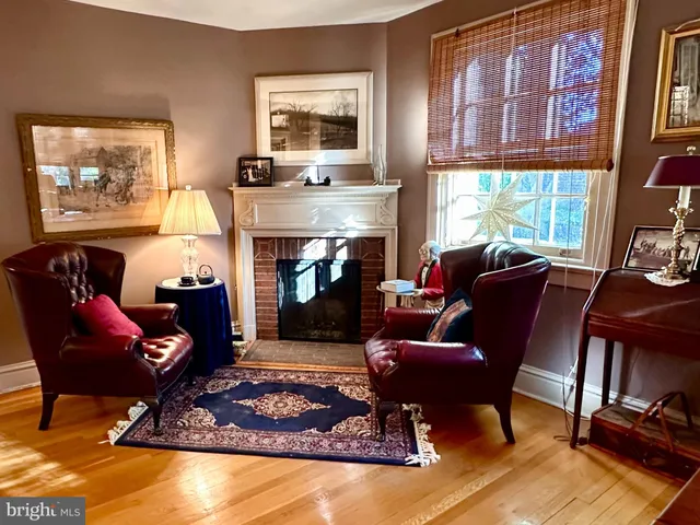 a living room with furniture fireplace and window