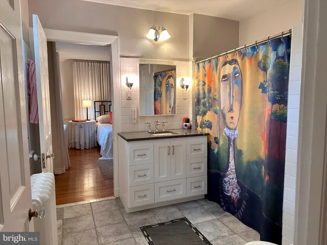 a bathroom with a sink a mirror and a shower