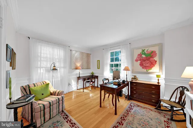a living room with furniture and a flat screen tv with wooden floor