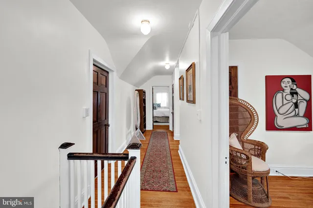 a view of a hallway with wooden floor and closet