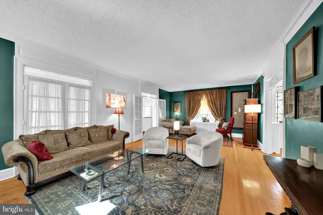 a living room with furniture fireplace and a large window