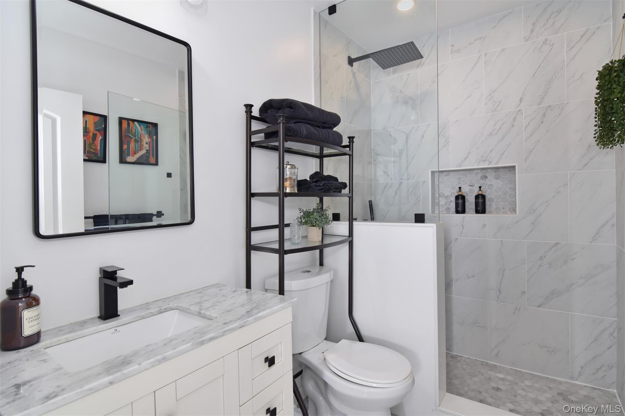 16 Badeau Place New Rochelle, NY 10801 - Photo 15 of 27 a bathroom with a granite countertop sink mirror vanity and toilet