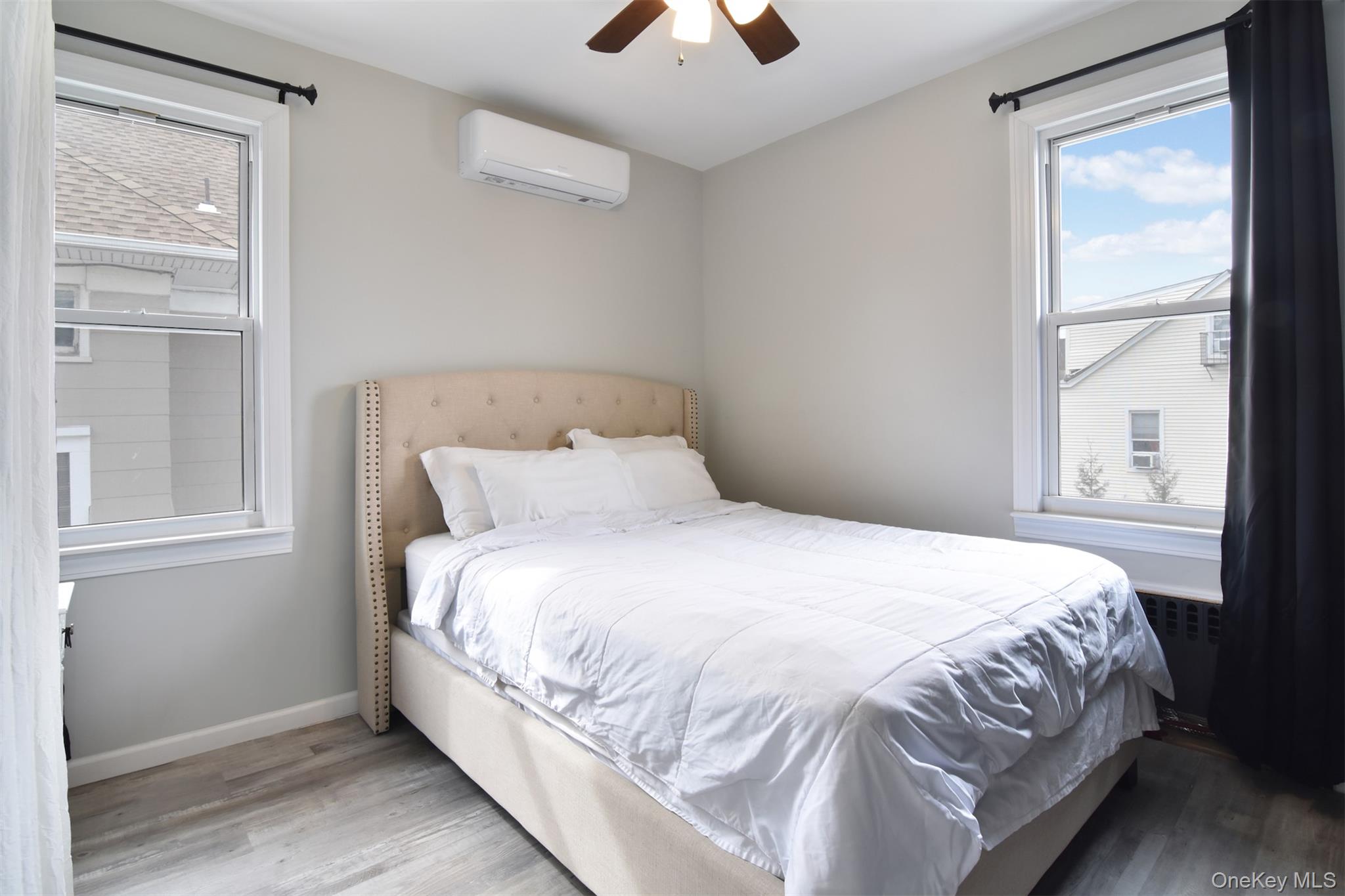 16 Badeau Place New Rochelle, NY 10801 - Photo 17 of 27 a large bed sitting in a bedroom next to a window