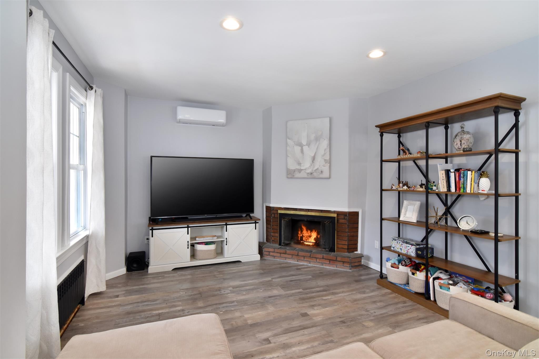 16 Badeau Place New Rochelle, NY 10801 - Photo 3 of 27 a living room with fireplace furniture and a flat screen tv
