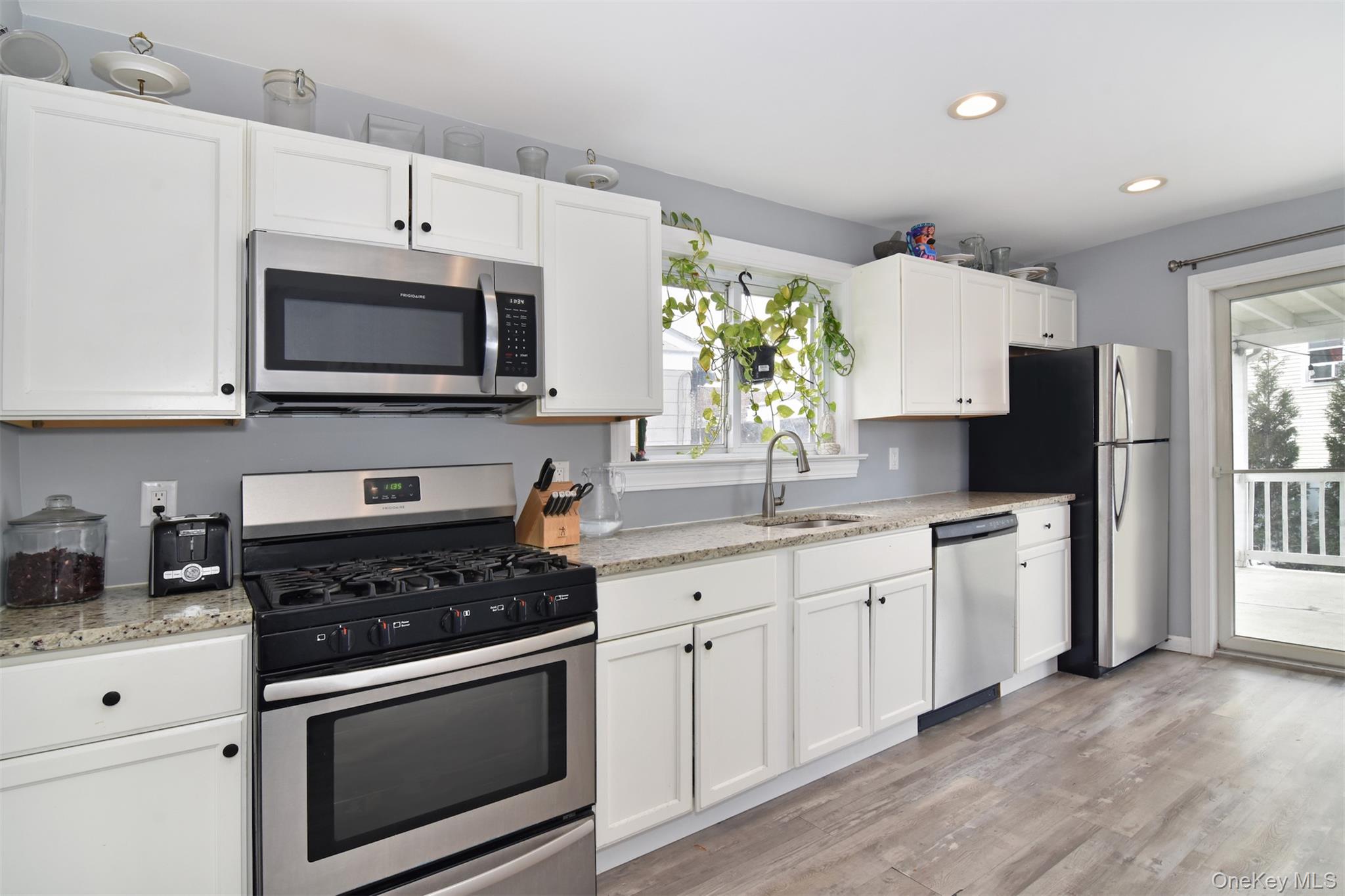 16 Badeau Place New Rochelle, NY 10801 - Photo 5 of 27 a kitchen with granite countertop a sink stove and microwave