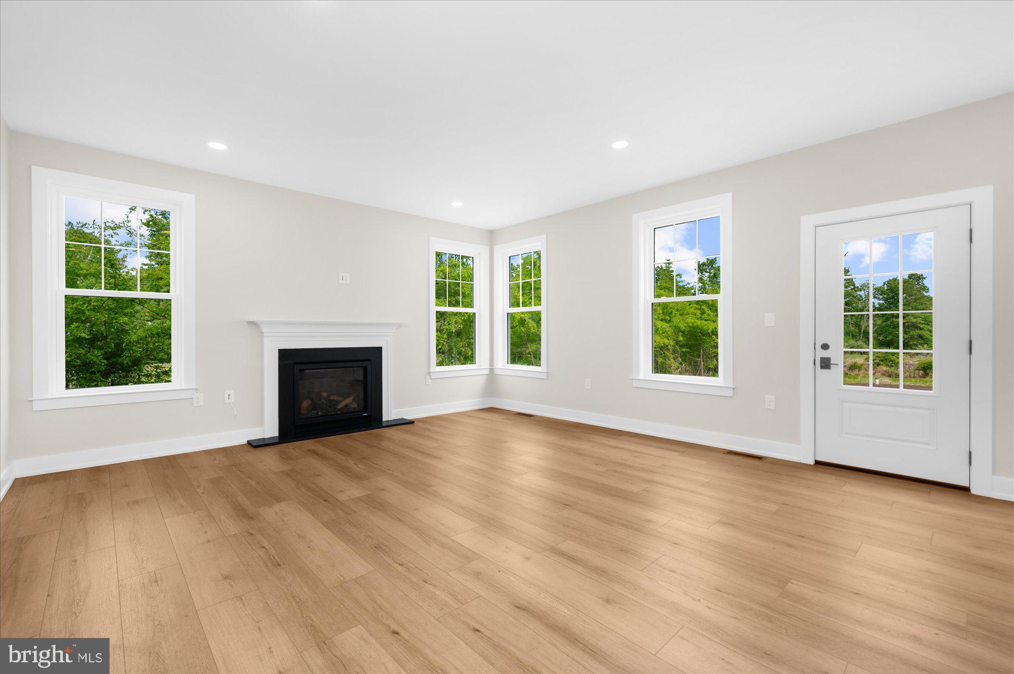 394 Renninger Road Perkiomenville, PA 18074 - Photo 16 of 41 a view of empty room with wooden floor and fireplace