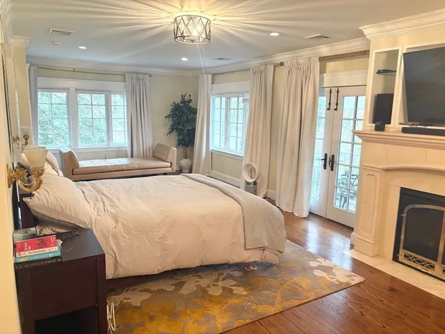 a view of a lake with a yard and large trees