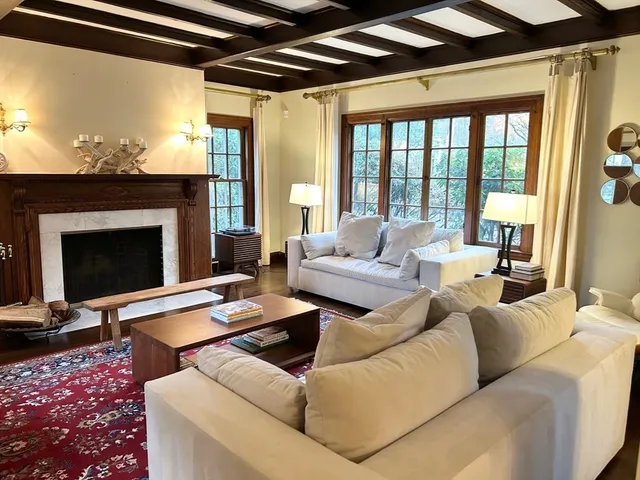a kitchen with granite countertop white cabinets and window