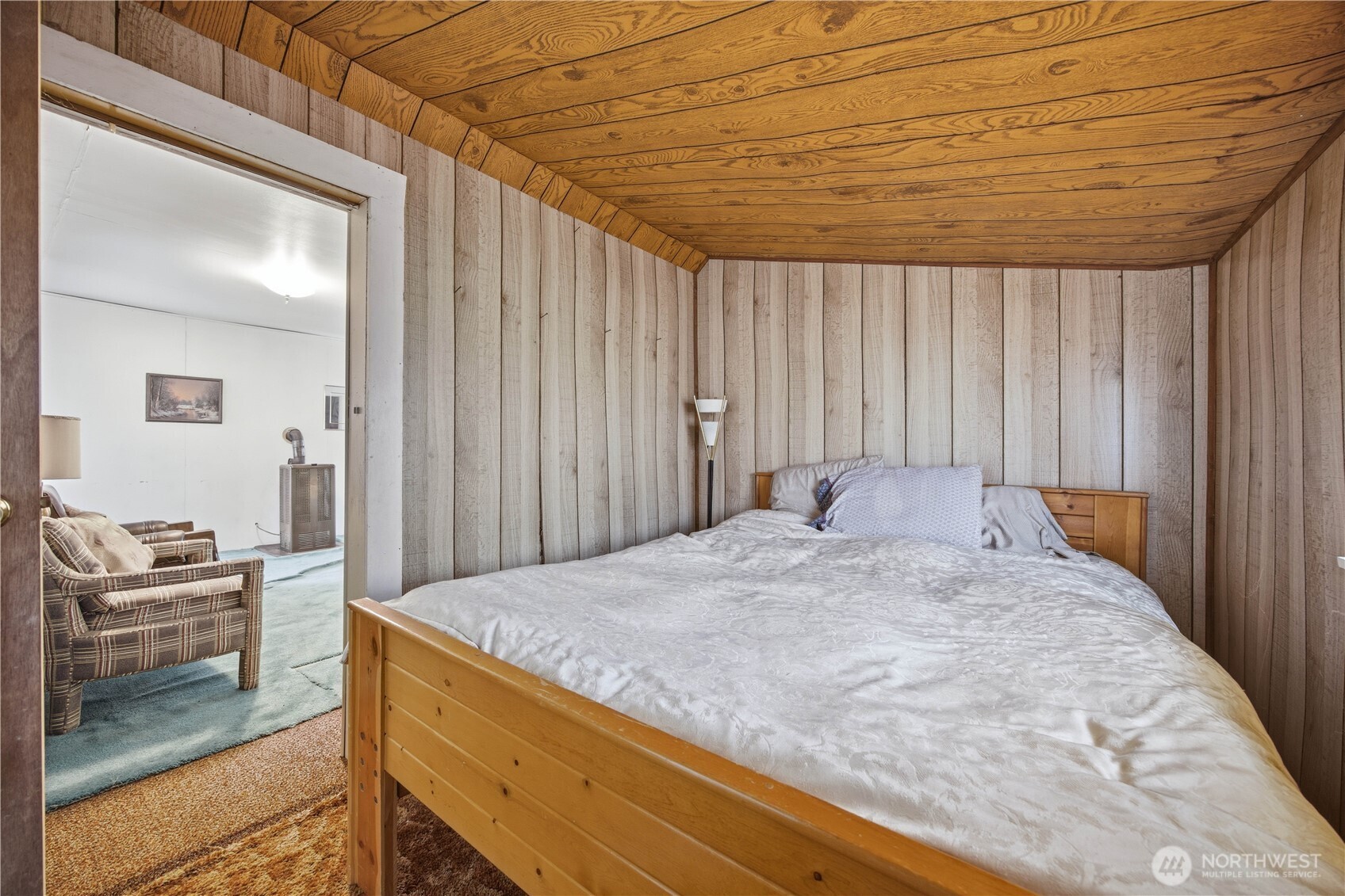 38 A Main Street Methow, WA 98834 - Photo 17 of 34 a bed sitting in a spacious bedroom next to a window