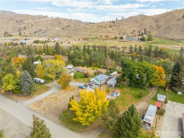 an aerial view of residential houses with outdoor space and lake view