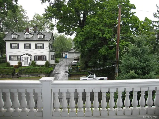 a view of a house with a wooden fence