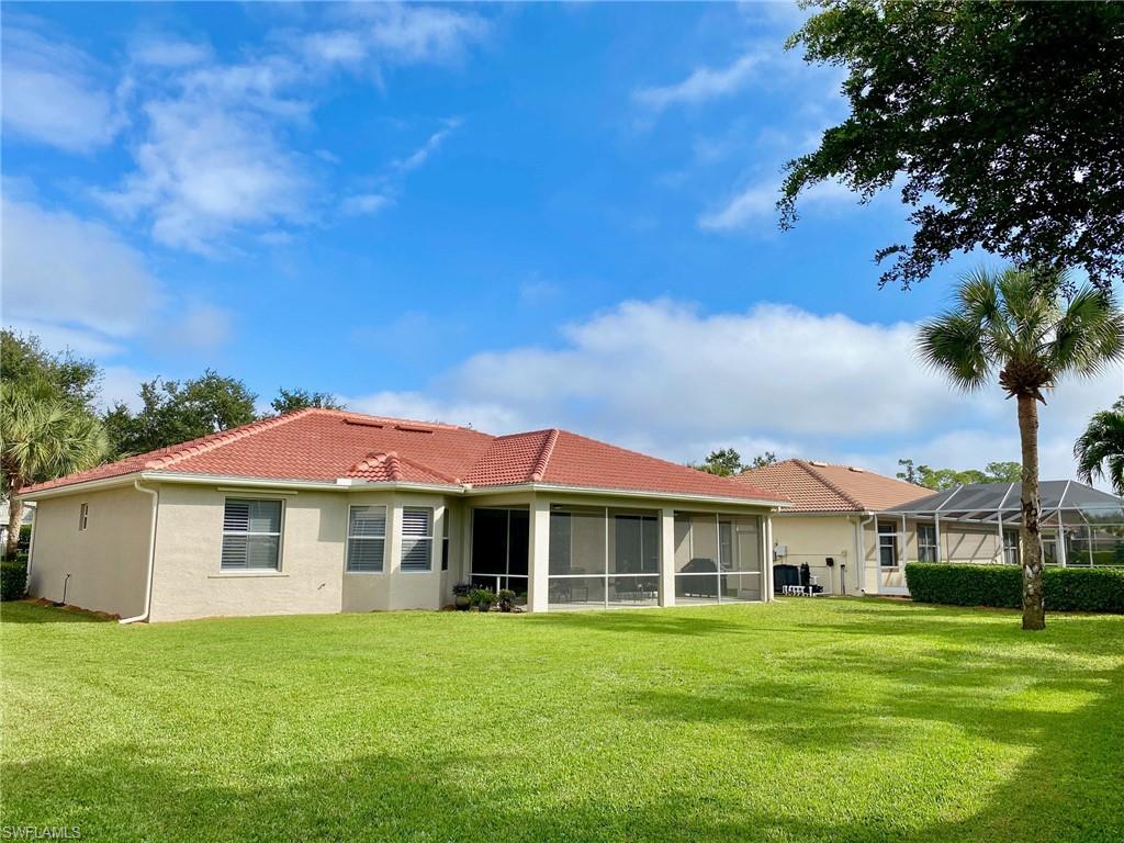 3955 Ruxton Road Naples, FL 34116 - Photo 21 of 23 a front view of a house with a garden