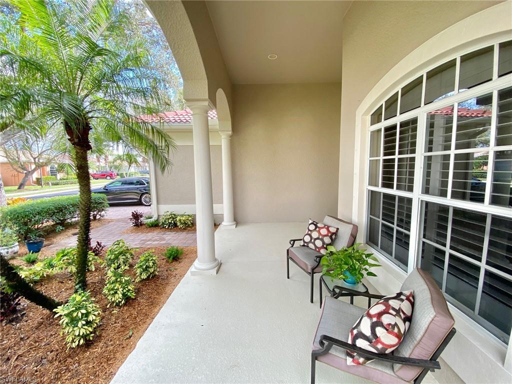 3955 Ruxton Road Naples, FL 34116 - Photo 5 of 23 a wooden bench sitting in front of a building