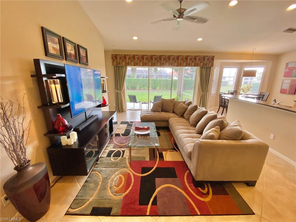 3955 Ruxton Road Naples, FL 34116 - Photo 8 of 23 a living room with furniture and a floor to ceiling window